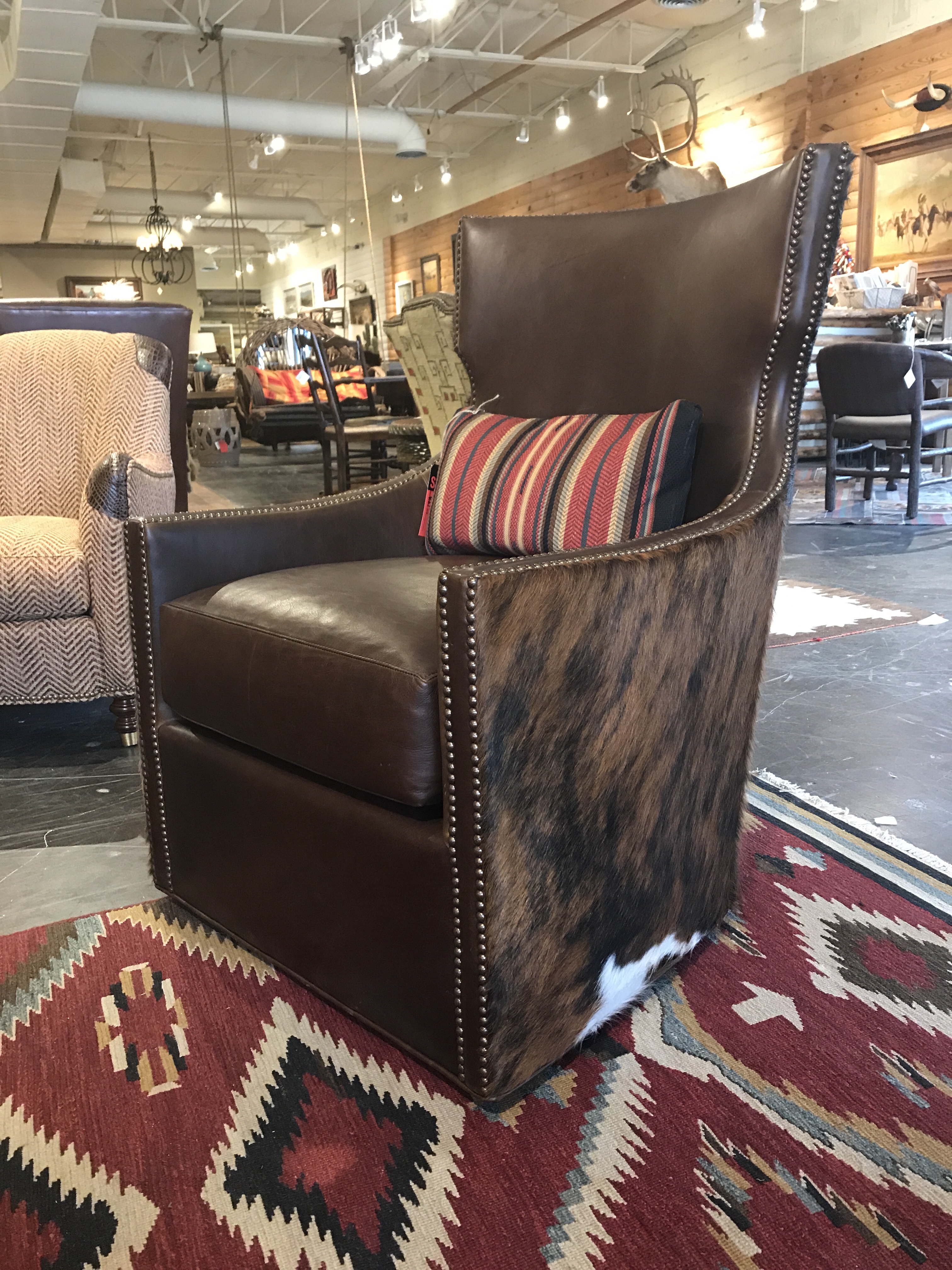 Leather And Cowhide Swivel Chair At Anteks Furniture Store In Dallas